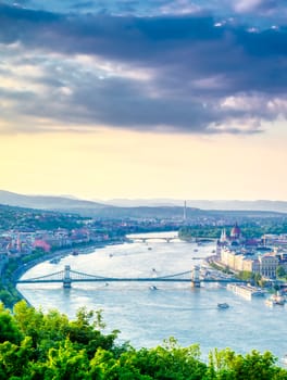 A view along the Danube River of Budapest, Hungary from Gellert Hill at sunset.