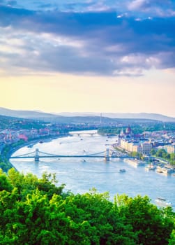 A view along the Danube River of Budapest, Hungary from Gellert Hill at sunset.