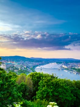 A view along the Danube River of Budapest, Hungary from Gellert Hill at sunset.