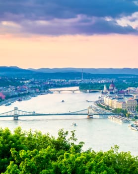 A view along the Danube River of Budapest, Hungary from Gellert Hill at sunset.