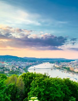 A view along the Danube River of Budapest, Hungary from Gellert Hill at sunset.