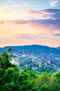 A view along the Danube River of Budapest, Hungary from Gellert Hill at sunset.