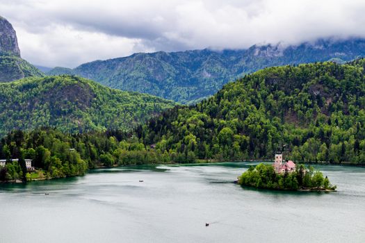 Lake Bled with St. Marys Church of Assumption on small island. Bled, Slovenia, Europe. Mountains and valley on background. Areal view from above.