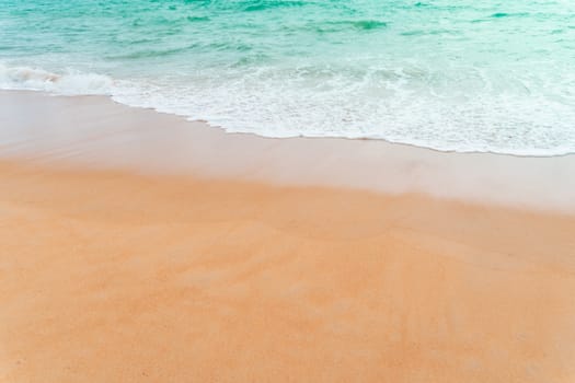 Top view of sand and water clean beach and white sand in summer with sun light blue sky and bokeh abstract  background.