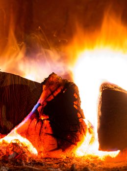 Red and orange crackling fire from burning woods