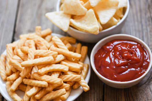 crunchy prawn crackers or shrimp crisp rice and ketchup for traditional snack / prawn crackers stick on white plate and wooden table background