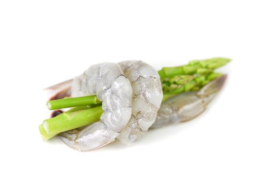 Asparagus Shrimp / Fresh raw shrimps prawns wrapped around green asparagus on white background 