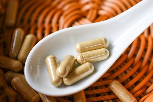 Herbal medicine extract from nature Non-toxic drug organic product on spoon / Herbal capsules from herbs healthy lifestyle