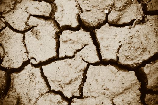 Cracks of the dried soil in arid season / Arid soil , Cracked earth texture of ground broken and rough surface mud clay top view 