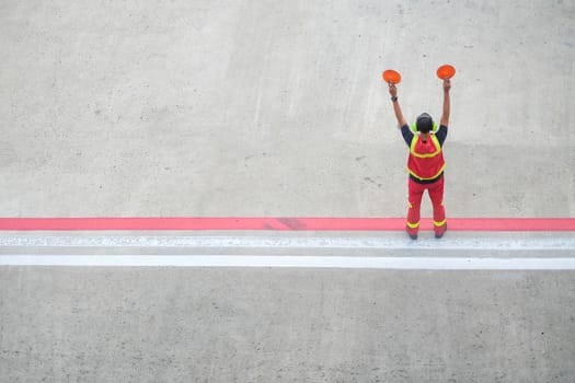 worker holding stop sign