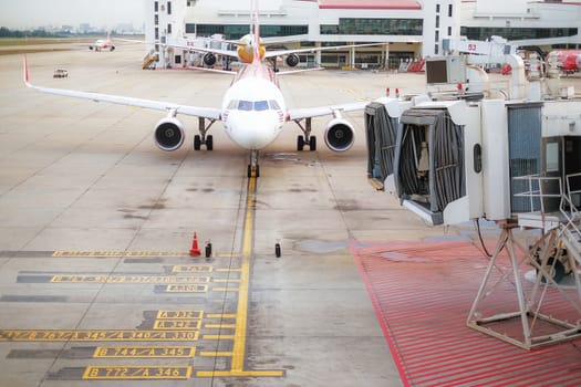 BANGKOK , THAILAND- JANUARY 17,2016: Passengers boarding airplane of AirAsia at the Don Mueang airport on January 17,2016