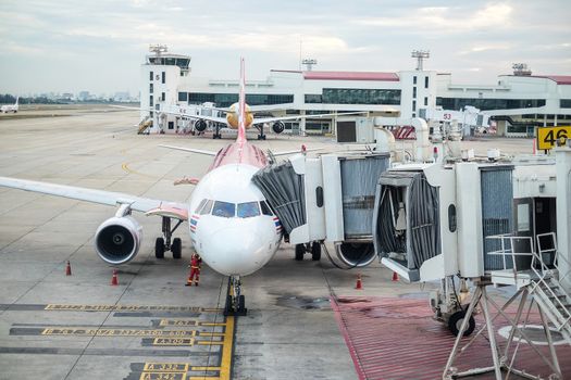 BANGKOK , THAILAND- JANUARY 17,2016: Passengers boarding airplane of AirAsia at the Don Mueang airport on January 17,2016