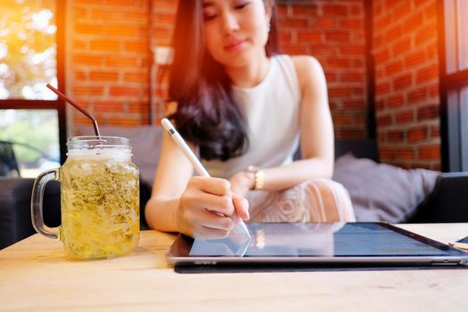 close up of a business woman analyzing business graphs on digital tablet