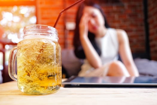 Beautiful woman in depression, drinking alcohol in The cafe