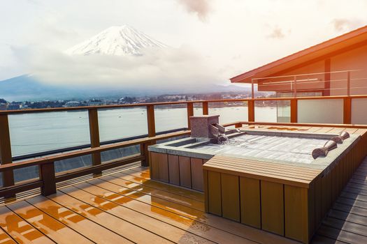 Japanese open air hot spa onsen with view of the mountain Fuji