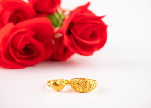 Wedding celebration on valentines day with red rose bouquet, wedding rings, isolated on white background. Concept of love and romance.