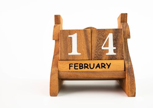 Wooden calendar on February 14 date, isolated on white background. Concept of Valentine's day.