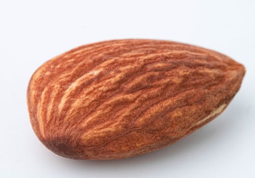 Macro shot of Almond nut isolated on white background.