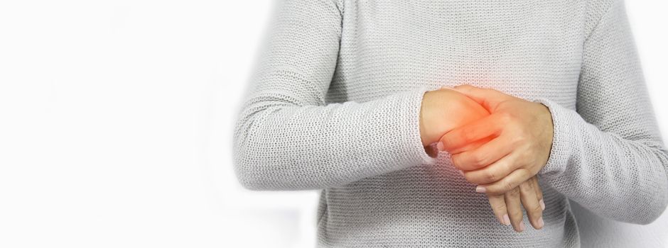 Young women hold her wrist with suffering from arthritis or Carpal tunnel syndrome from work, isolated on white background.