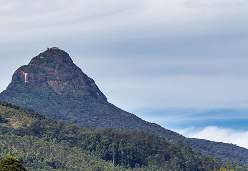 Sunrise over Adam's peak, Sri Lanka, mountain in the fog view from the jungle. Mountain landscape.