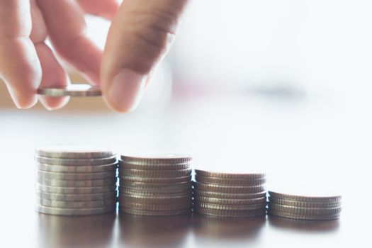 Business financial success concept. Gold coins on table and green nature bokeh background.Bullish market situation.