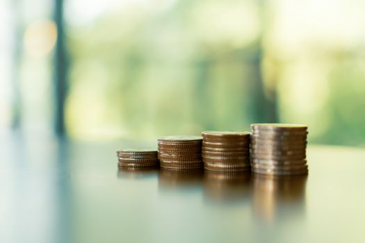 Business financial success concept. Gold coins on table and green nature bokeh background.Bullish market situation.