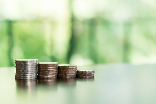 Business financial success concept. Gold coins on table and green nature bokeh background.Bullish market situation.