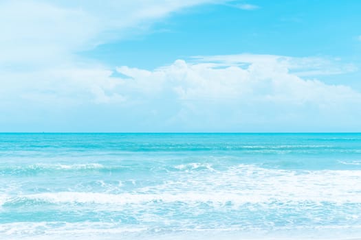 Tropical nature clean beach and white sand in summer with palm tree leaf sun light blue sky and bokeh abstract  background.