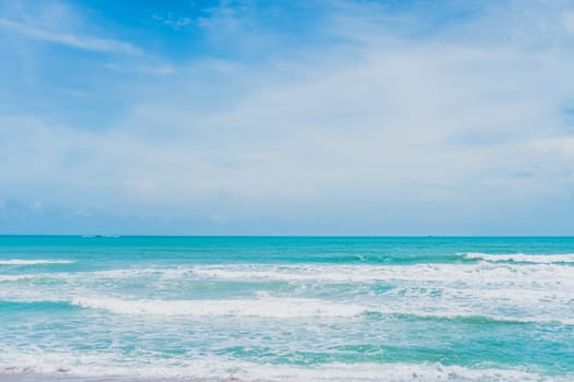 Tropical nature clean beach and white sand in summer with palm tree leaf sun light blue sky and bokeh abstract  background.