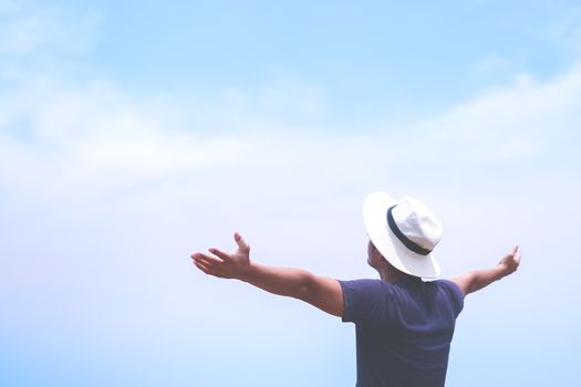 Man rise hands up to sky freedom concept with sunset sky and summer beach background.