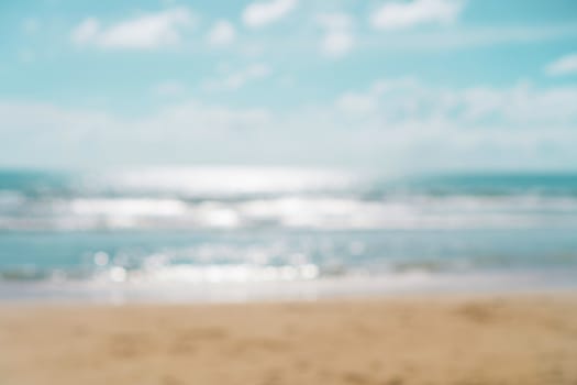 Blur summer bokeh beach with sun light and blue sky background.