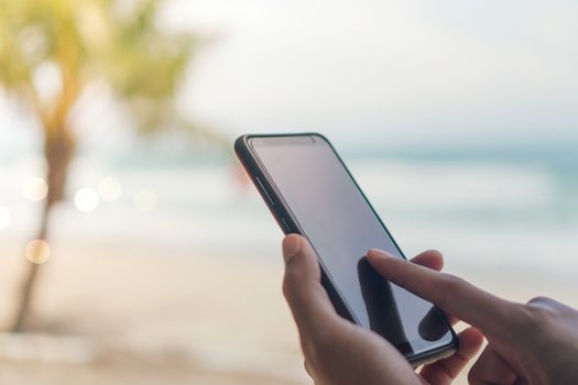 Woman hand using smartphone to do work business, social network, communication in public outdoor.