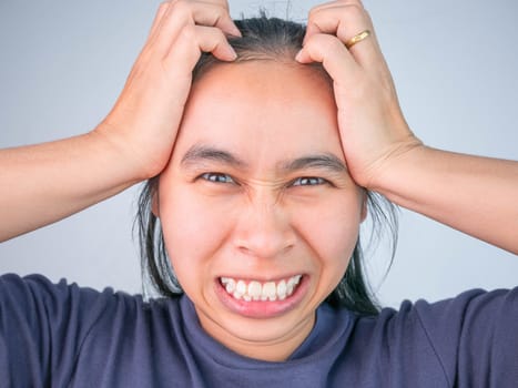 Woman catching on head because she have acute headache. Healthcare and medical concepts.