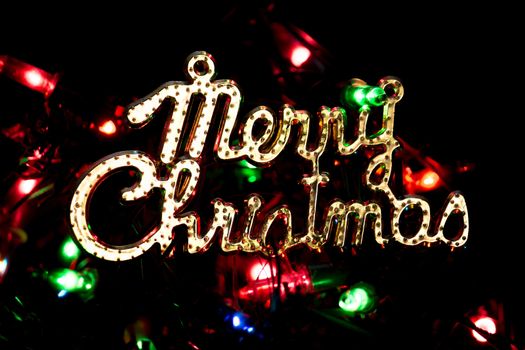 Merry Christmas on dark background with lights bokeh sparkle background presents for new year.