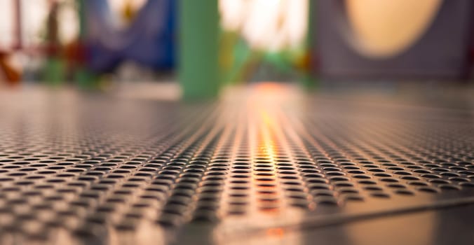 Close-up of Steel floor on kid's playground activity tower equipment outdoors.