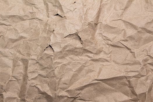 Close up of crumpled brown paper texture and torn.