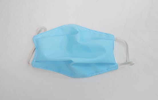 Homemade protective facial mask, making from cloth use for protection from air pollution or virus epidemic, isolated on white background. Health care concept.