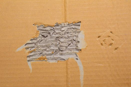 Torn corrugated brown cardboard sheet abstract background, texture of recycle paper box for design art work.