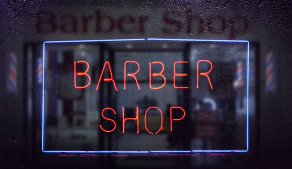 Vintage Neon Barber Shop Sign in Rainy Window