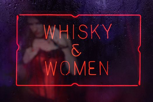 Vintage Neon Whisky and Women Sign in Rainy Window