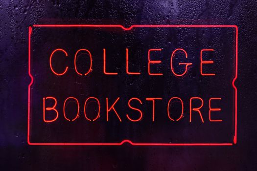 Neon College Bookstore Sign in Rainy Window