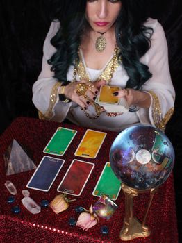 Psychic with green hair  Crystal Ball and tarot cards Shallow DOF, Focus on Crystal Ball