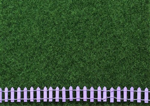 Artificial Green Grass With Picket Fence Background