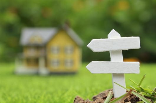 Rustic Signboard in Rural  Outdoor Area, Blurred Farmhouse in background