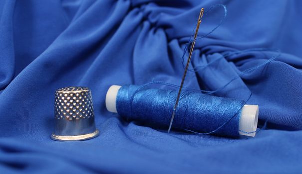 Blue Thread with needle and thimble on blue prom dress, Shallow DOF
