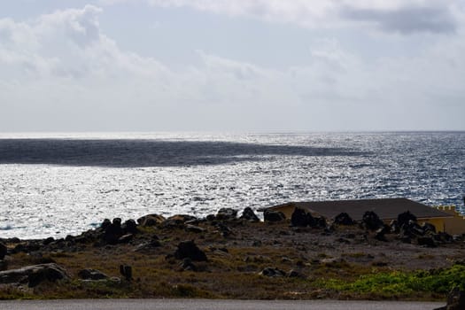 Arikok Natural Park on the island of Aruba in the Caribbean Sea with deserts and ocean waves on the rocky coast