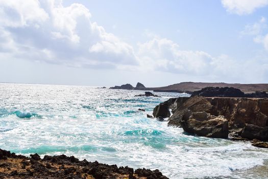 Arikok Natural Park on the island of Aruba in the Caribbean Sea with deserts and ocean waves on the rocky coast