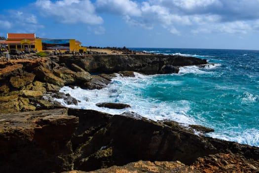 Arikok Natural Park on the island of Aruba in the Caribbean Sea with deserts and ocean waves on the rocky coast