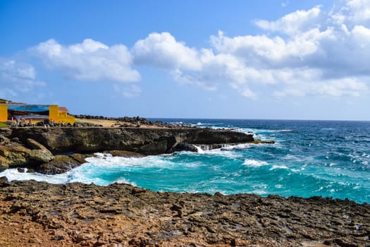 Arikok Natural Park on the island of Aruba in the Caribbean Sea with deserts and ocean waves on the rocky coast