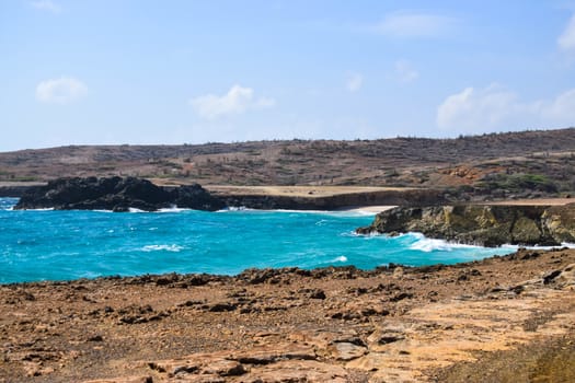 Arikok Natural Park on the island of Aruba in the Caribbean Sea with deserts and ocean waves on the rocky coast